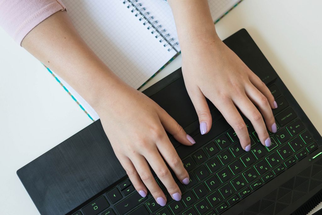 High Angle View of Woman's Hands Working on the Laptop