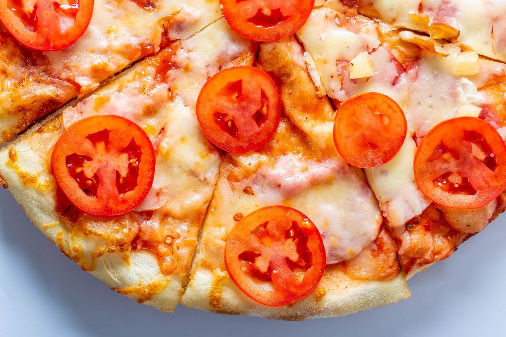 Homemade pizza with cheese and tomatoes