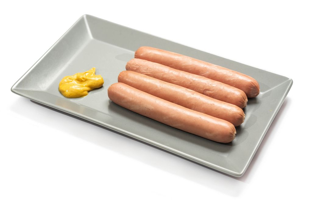 Hot dog Frankfurters with mustard on the plate