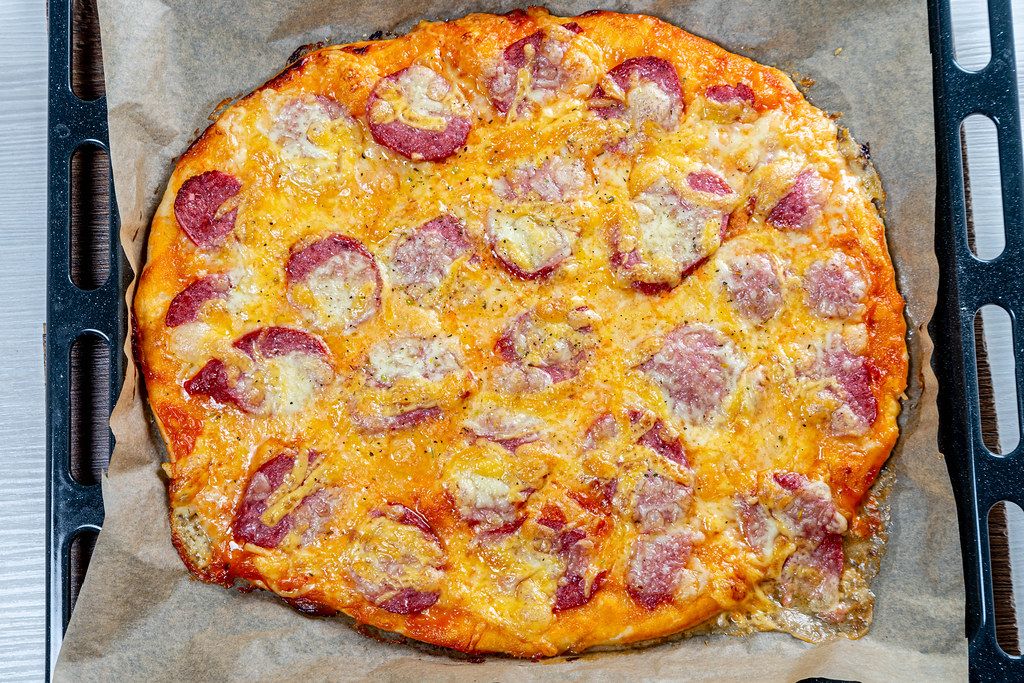 Hot homemade pizza on a baking sheet (Flip 2019)