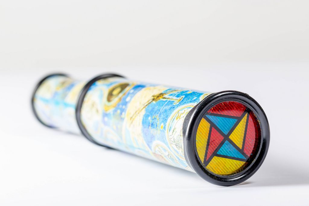 Kaleidoscope with colored glasses on white background