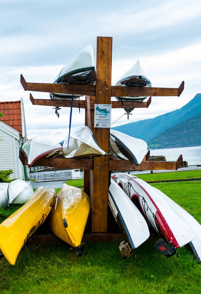 Kayak rental stand with colorful kayaks in the Norwegian countryside (Flip 2019)