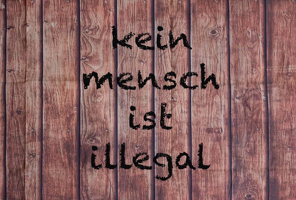 Kein Mensch ist illegal written on a wooden wall
