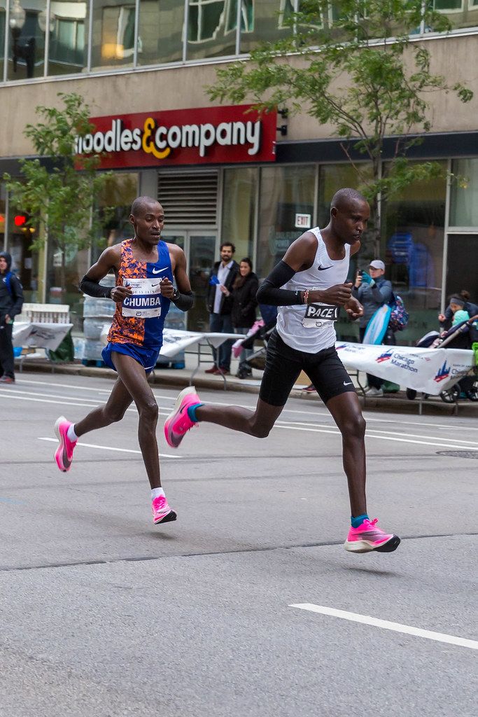 Kenyan athlete Dickson Chumba and a pacer running the Chicago Marathon ...