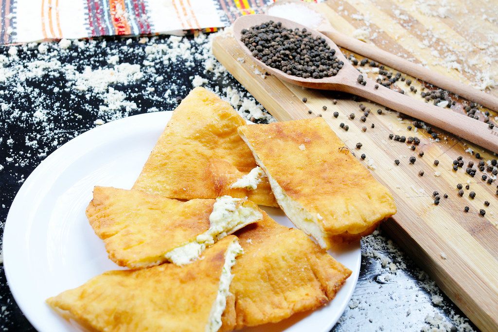 Langos with cheese, Hungarian traditional recipe. Black background (Flip 2019)