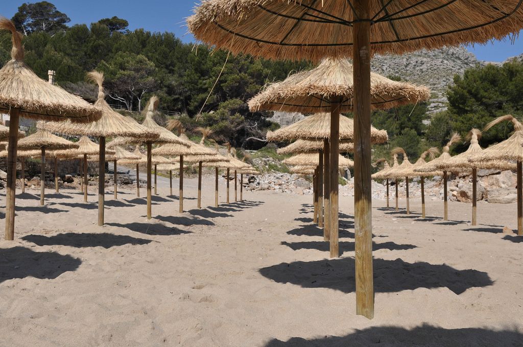 Leerer Strand mit Strohschirmen auf Mallorca
