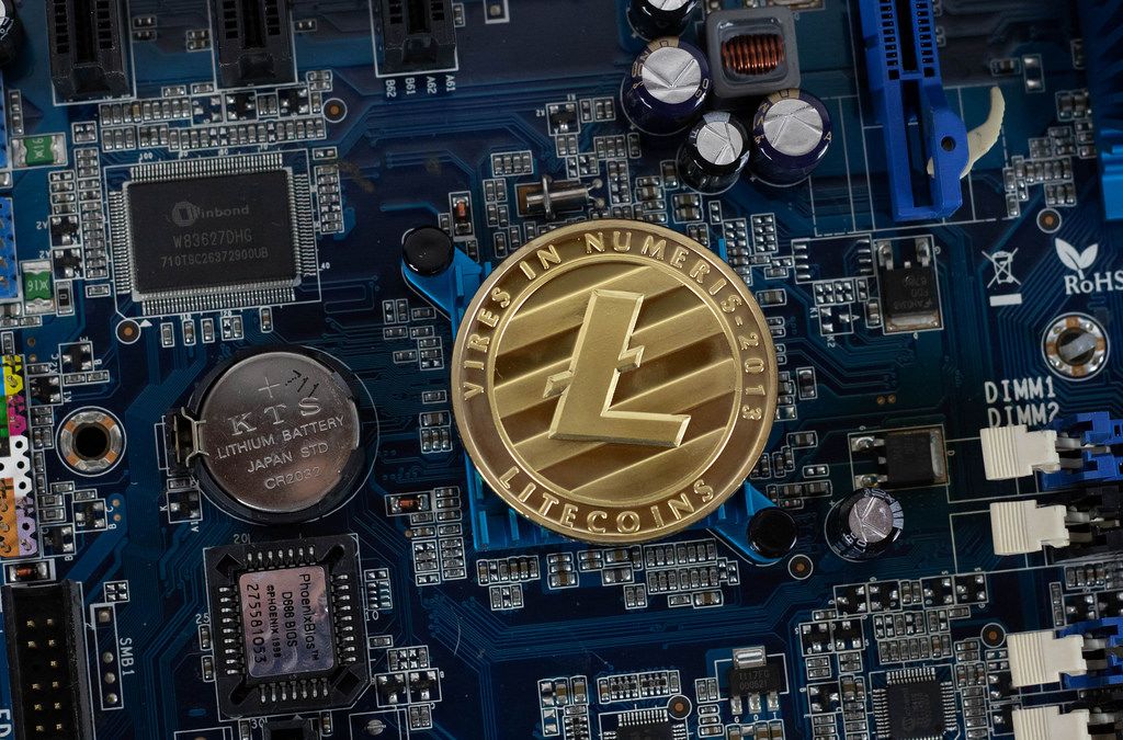 Litecoin crypto currency silver coin on hardware computer chip motherboard