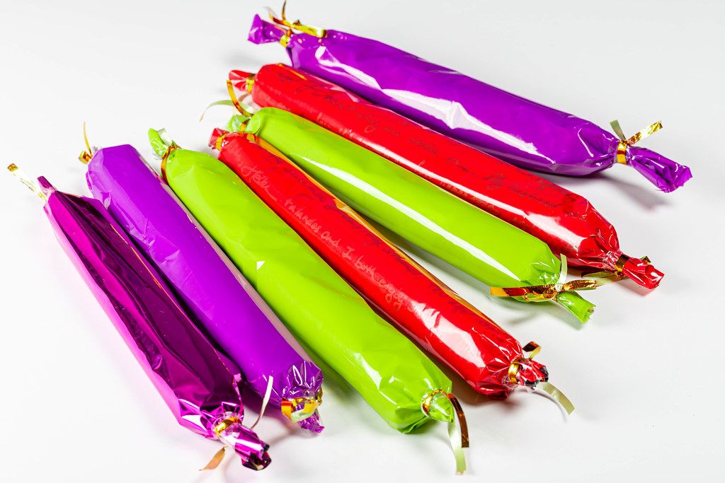 Long colored candies on a white background (Flip 2020)