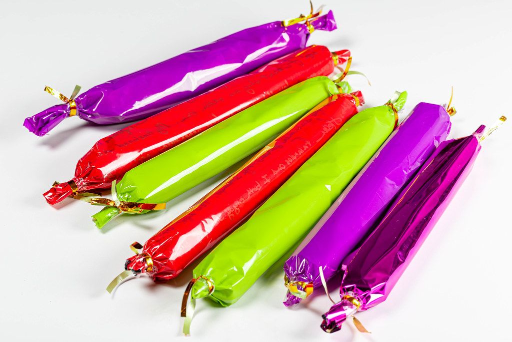 Long colored candies on a white background