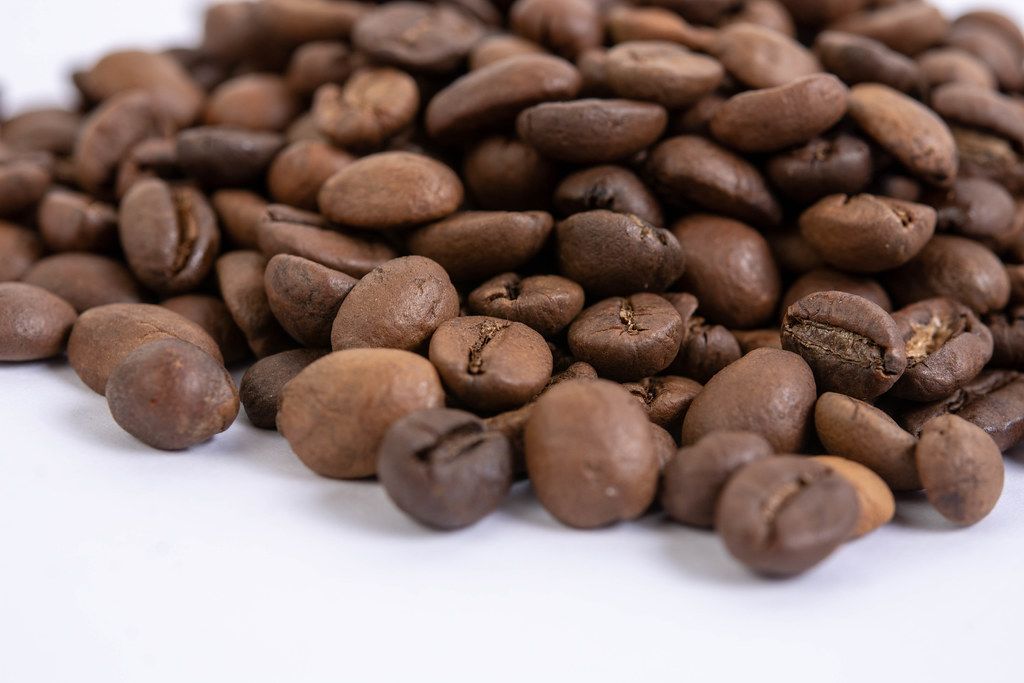 Macro fo Raw Coffee Beans on the white background
