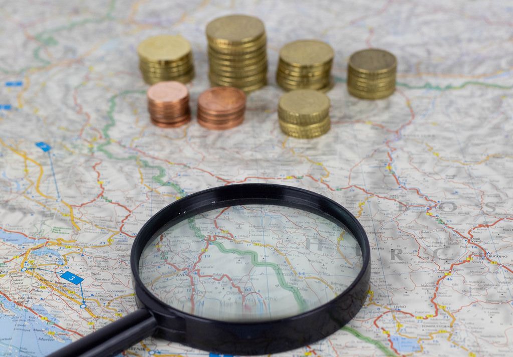 Magnify glass with money on map