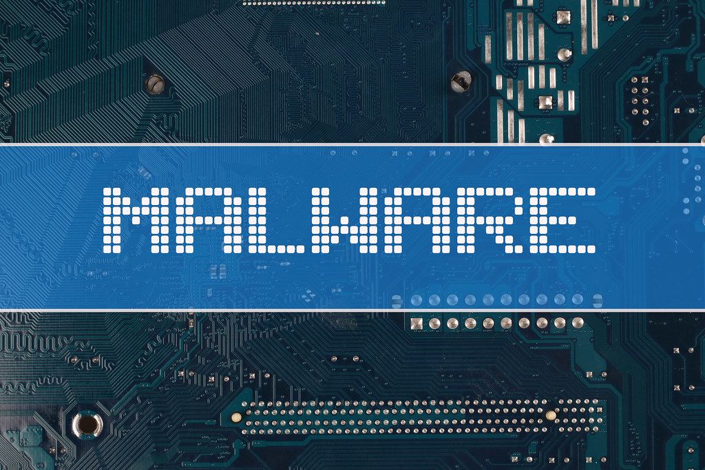Malware text over electronic circuit board background
