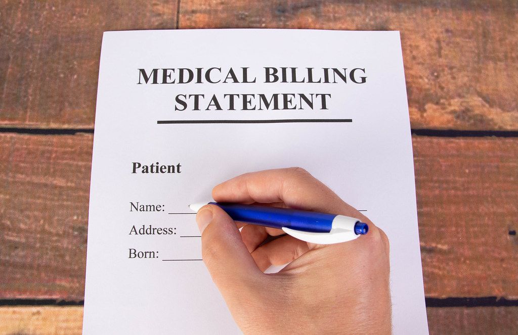 man-filling-out-medical-billing-statement-creative-commons-bilder