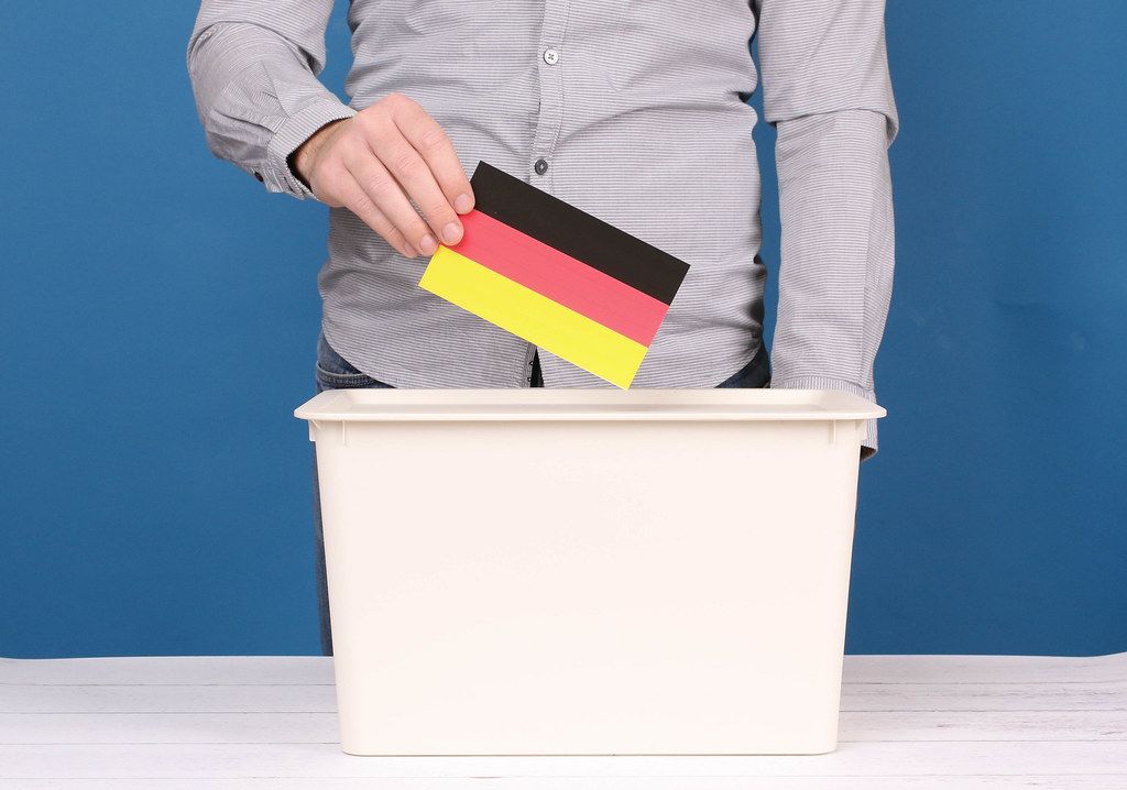 Man putting his vote in the ballot box in Germany