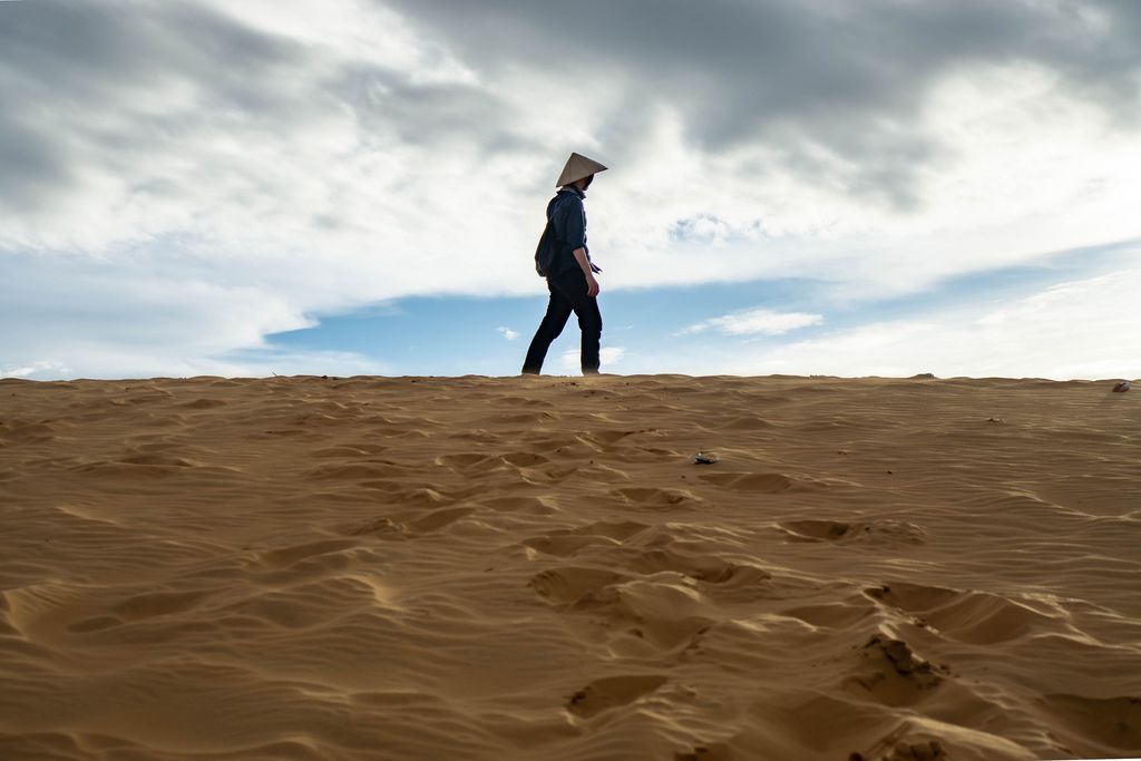 Man standing on Top of a Sand Dune in the Red Sand Dunes of Mui Ne, Vietnam (Flip 2019) (Flip 2019) Flip 2019