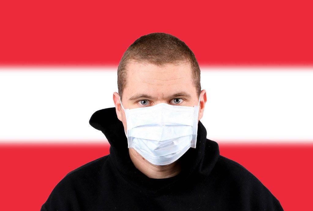 Man wearing protection face mask with flag of Austria