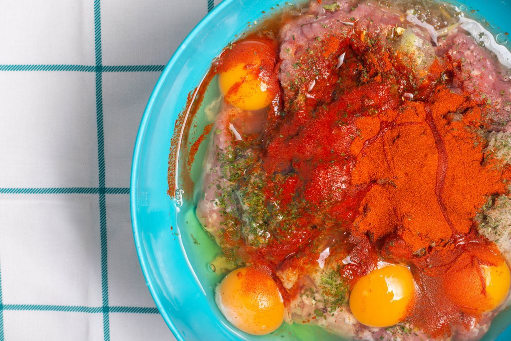 Meatballs mixture with red paprika smashed eggs pepper and other spices
