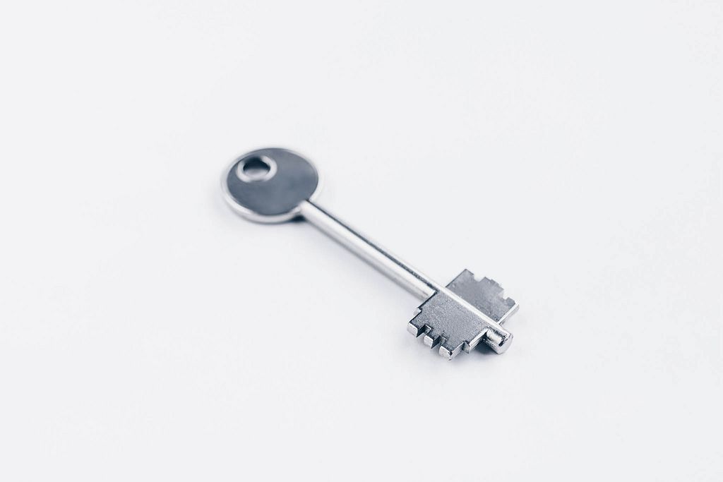 Metal key on white background