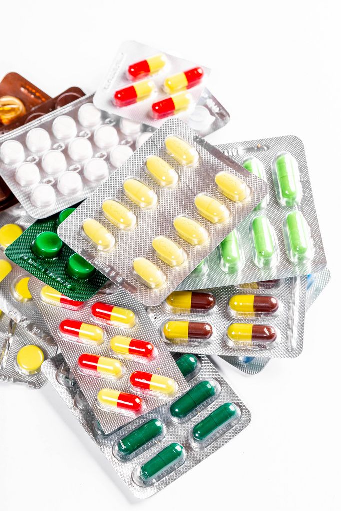 Multicolored tablets, capsules and pills in packages (Flip 2019)