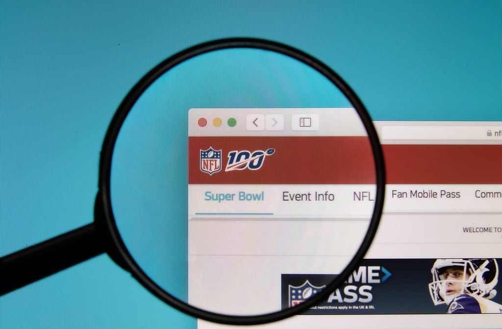 NFL logo on a computer screen with a magnifying glass