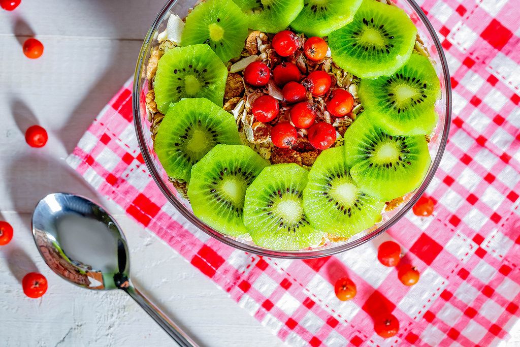 Oat flakes with kiwi slices and red berries for a full and healthy Breakfast