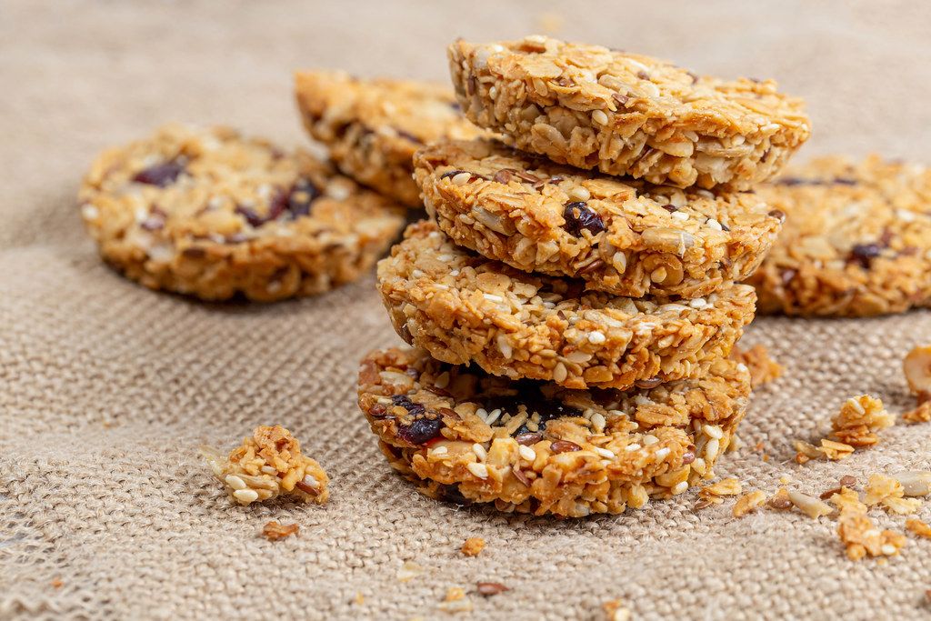 Oatmeal cookies with seeds and dried fruits on burlap