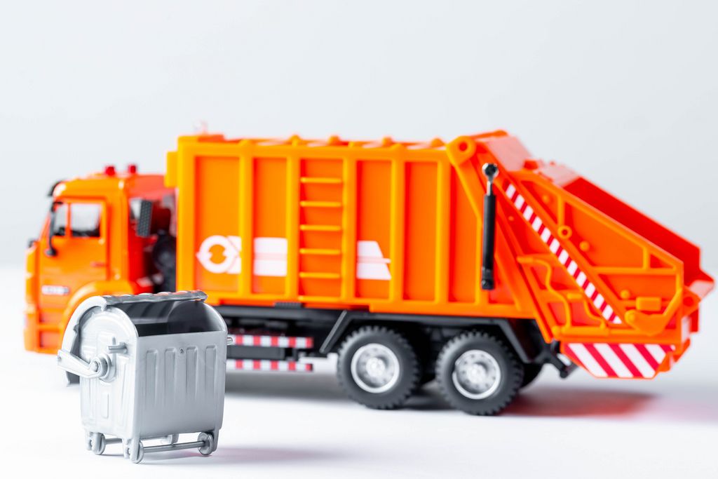 Orange garbage truck toy on a white background