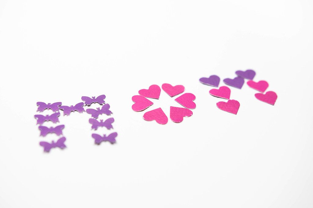 Paper butterflies and hearts forming the word MOM