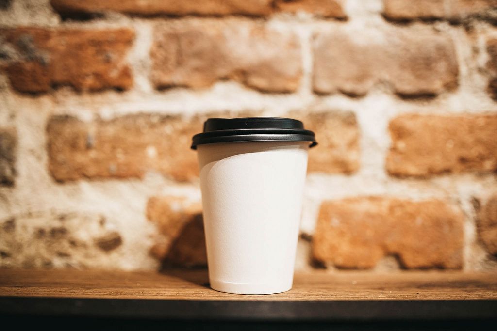 Paper coffee cup on brick wall background (Flip 2019) (Flip 2019) Flip 2019