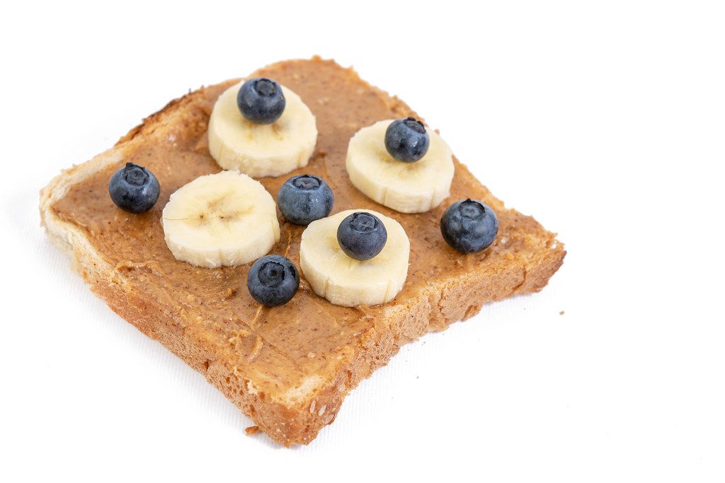 Peanut Butter on the toast bread with banana and blueberries