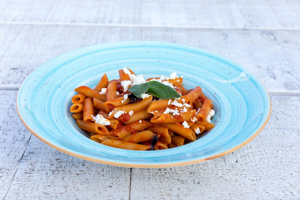 Penne pasta with tomato sauce and grated feta cheese