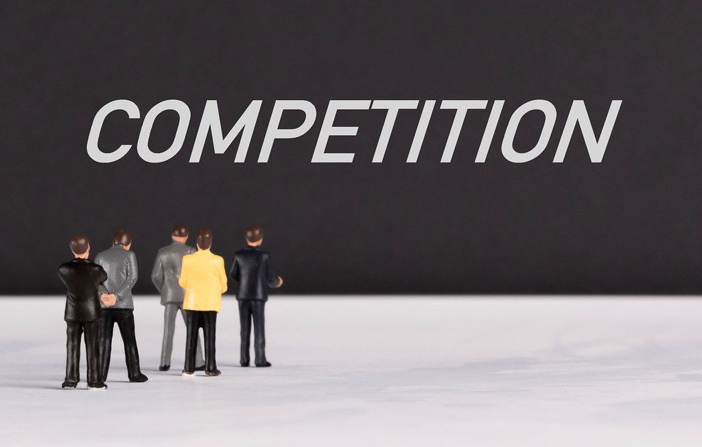 People standing in front of Competition text