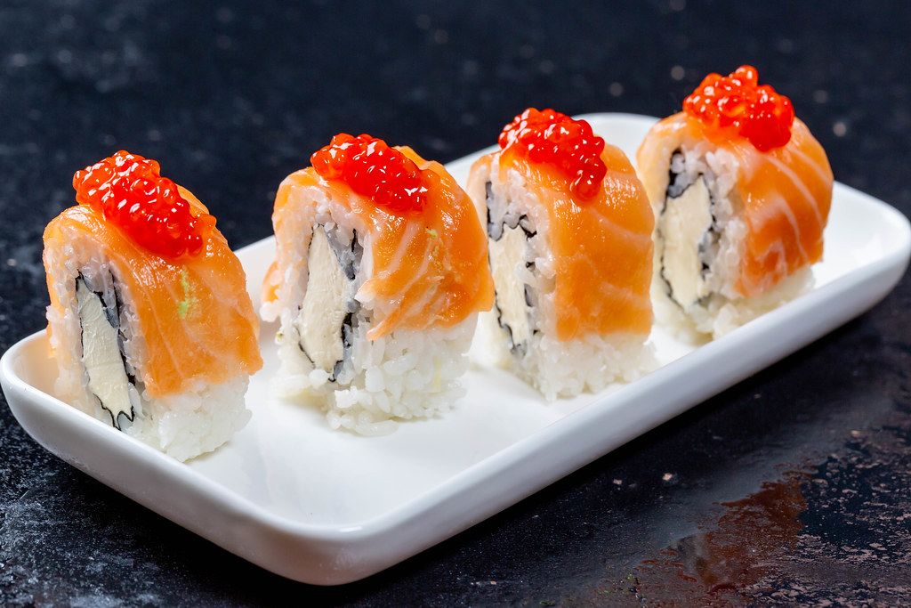 Philadelphia Sushi Rollen mit Lachs, Käse und rotem Kaviar-Topping auf ...