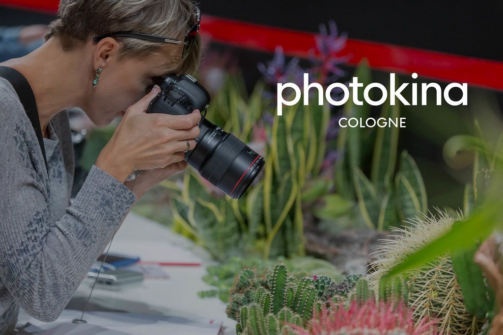 Photography fair visitor tests camera for nature photographs, next to picture title 