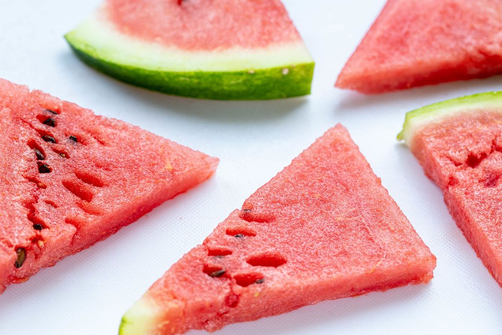 Pieces of fresh juicy watermelon on white background