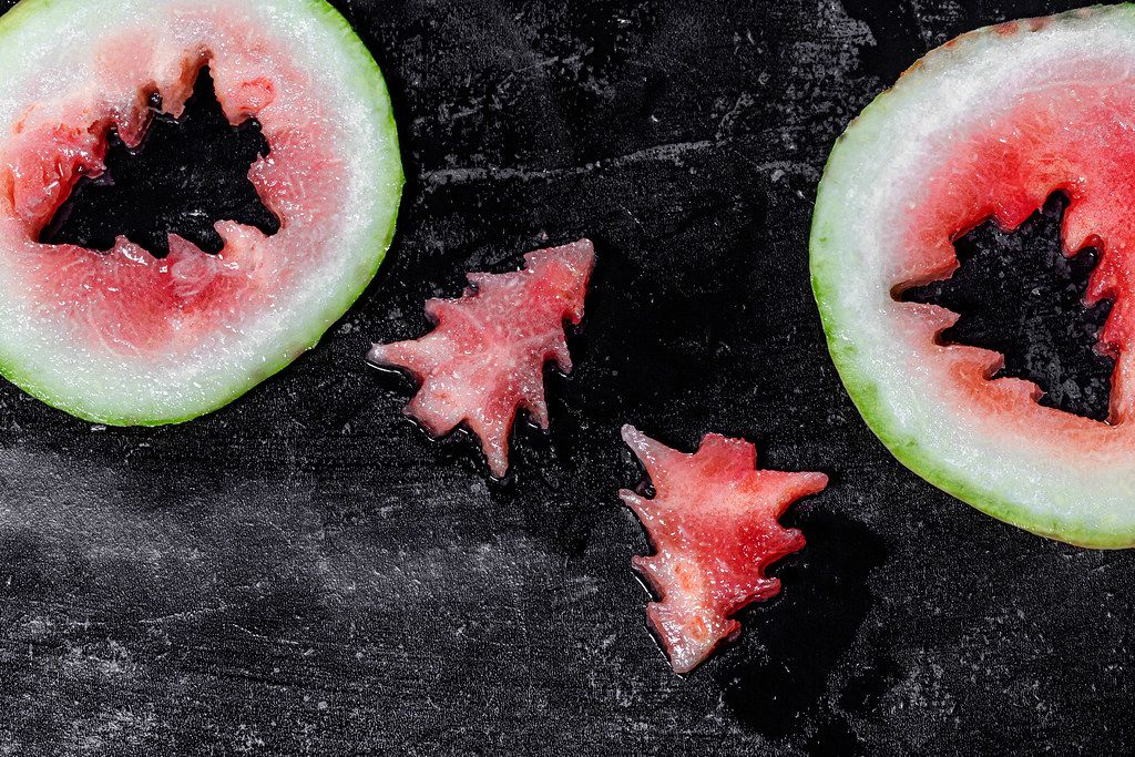 Pieces of watermelon in the shape of a Christmas tree on a black background (Flip 2019)