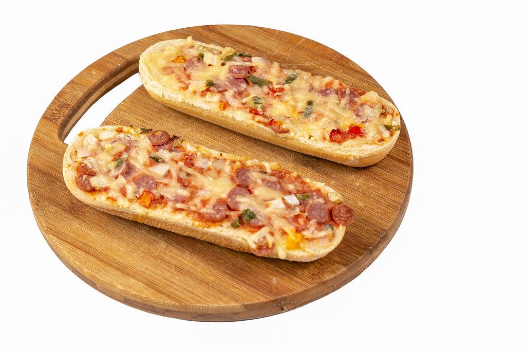 Pizza Baguette on the round wooden board (Flip 2019)