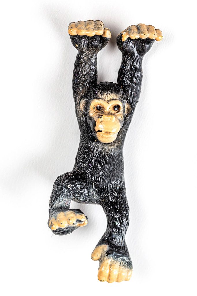 Plastic figure of a monkey on a white background