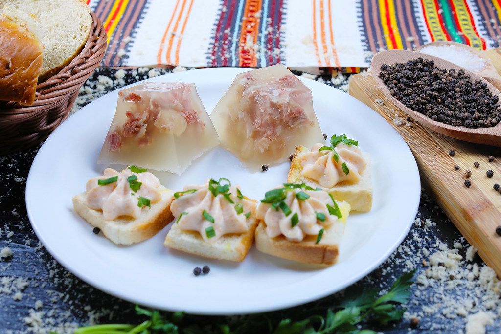 Pork jelly on white plate, traditional Balkan recipe (Flip 2019)