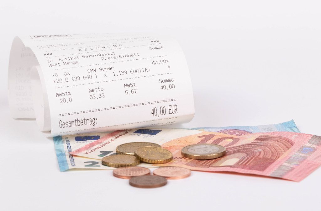 Printed receipt and Euro money on white background