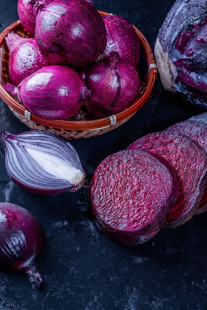Purple onion, cabbage and beet on black background