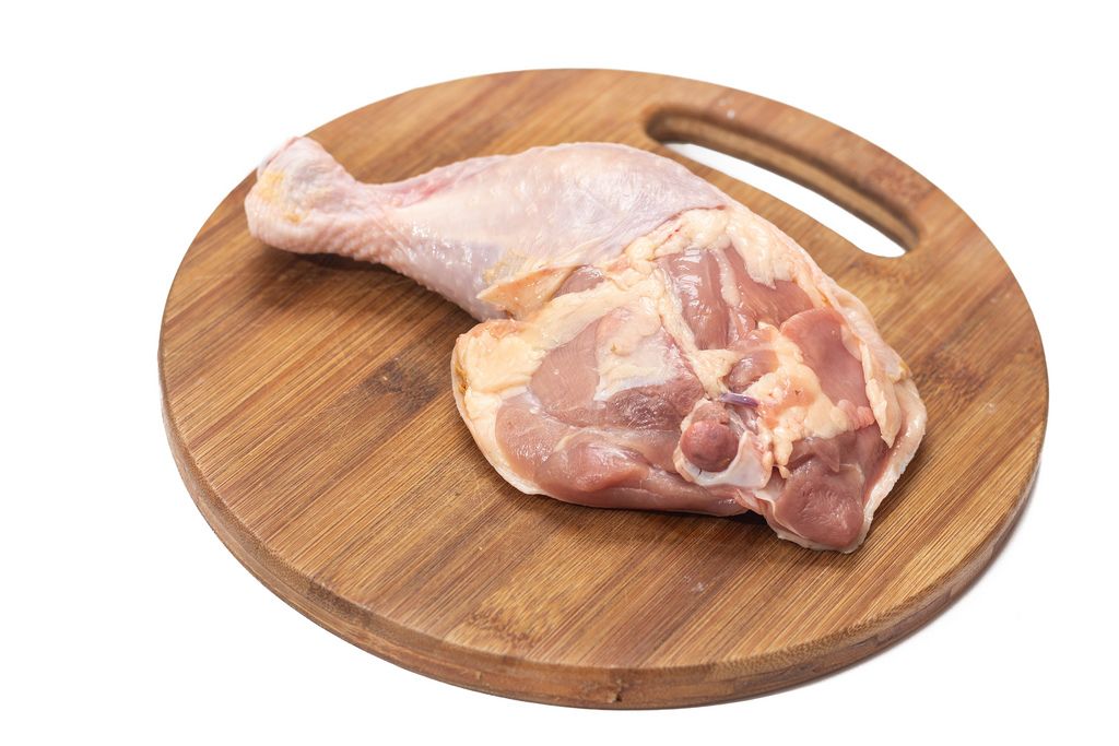 Raw Chicken Meat on the round wooden board