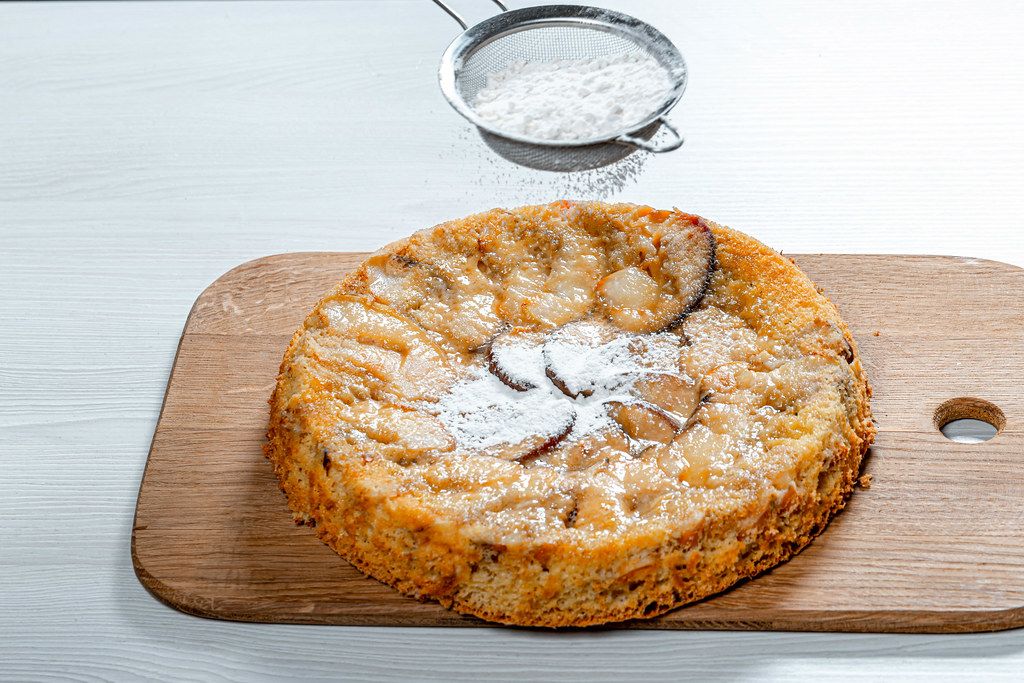 Ready homemade apple pie sprinkled with powdered sugar (Flip 2019)