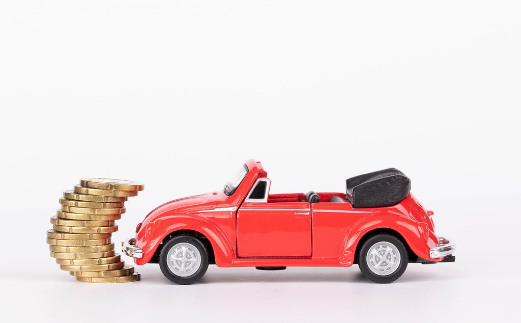 Red toy car with stack of coins