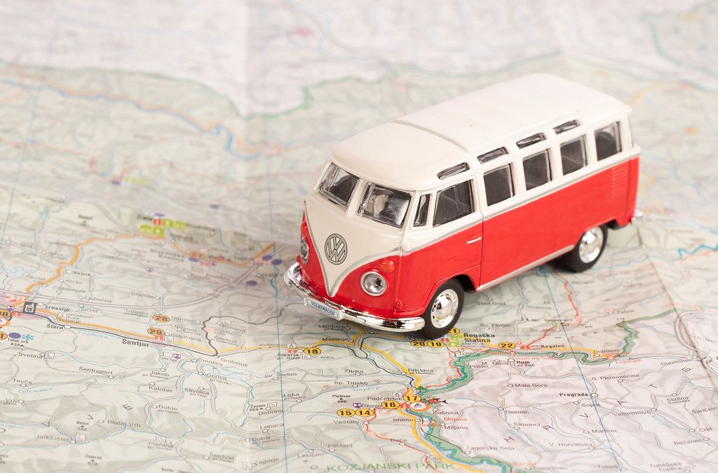 Red vintage camper van on map