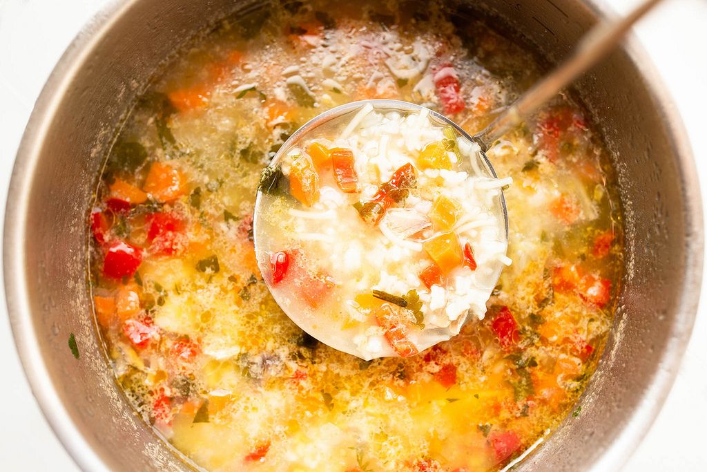 Rice chicken vegetable soup in saucepan with spoon (Flip 2019) (Flip 2019) Flip 2019