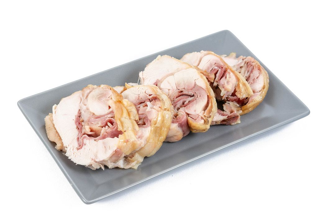 Rolled Chicken with Ham and Cheese served on the plate (Flip 2019) (Flip 2019) (Flip 2019)