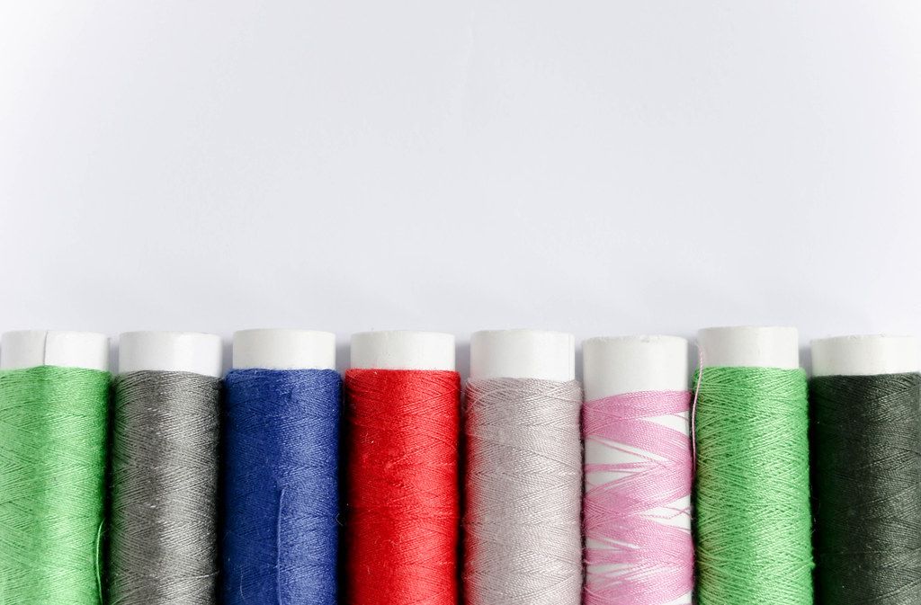 Rolled yarn of different colours on a white background