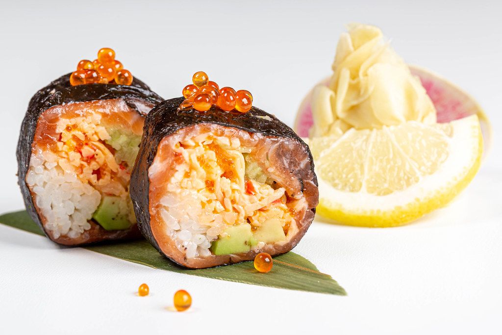 Rolls with nori, salmon, crab, rice, avocado, tobik caviar, salmon caviar and micro-greens