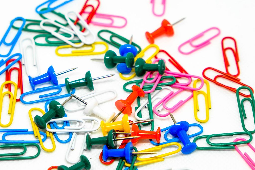 Scattered pins and paperclips